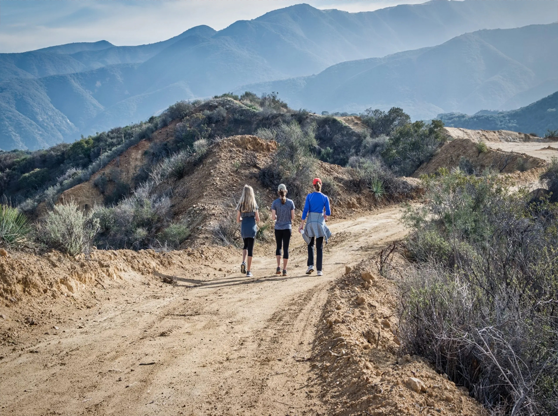 Travelers hiking a mountain trail